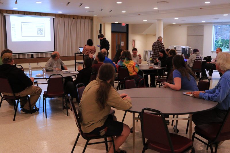 A room of community members seated at a planning meeting