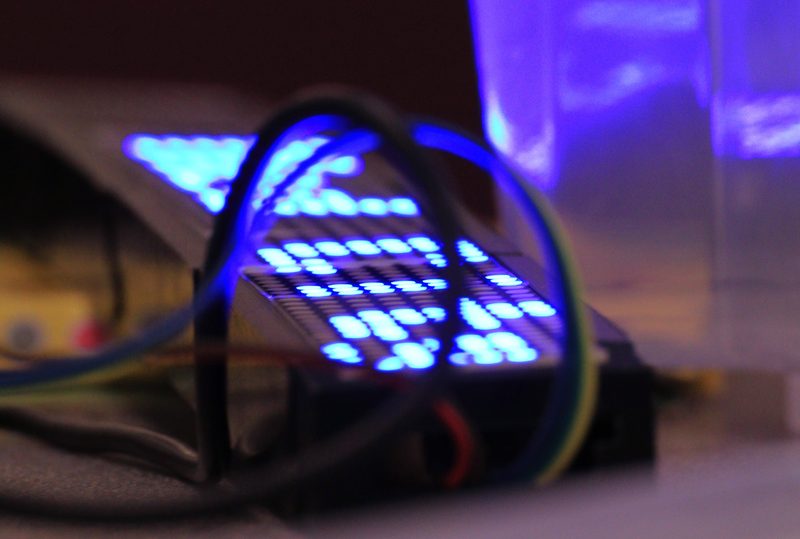 Close-up of a small electronics project with lit LEDs