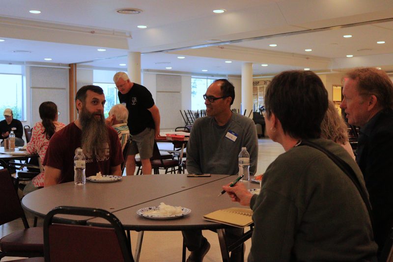Volunteers talking around a table at a meeting